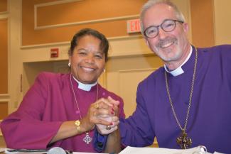 Bishop Gayle Harris clasps hands with Bishop Gates.