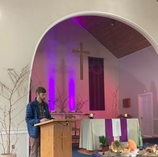 Gabriel Colombo helps lead pilgrimage worship service at St. Peter's Church in Dartmouth.