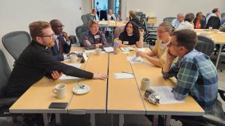 Small group table discussion at May 2025 Visioning Summit