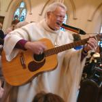Bishop Bud Cederholm with guitar